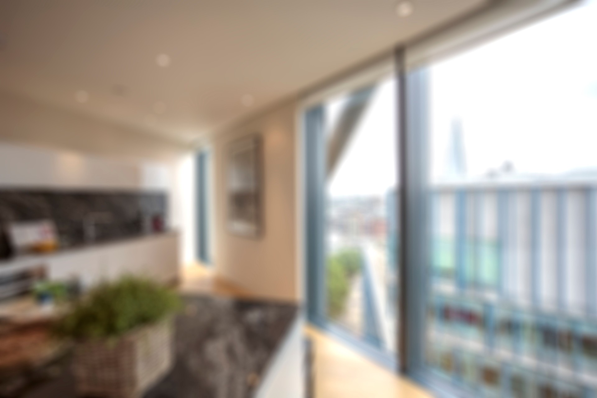 Defocused kitchen and living room of a contemporary luxury apartment in London