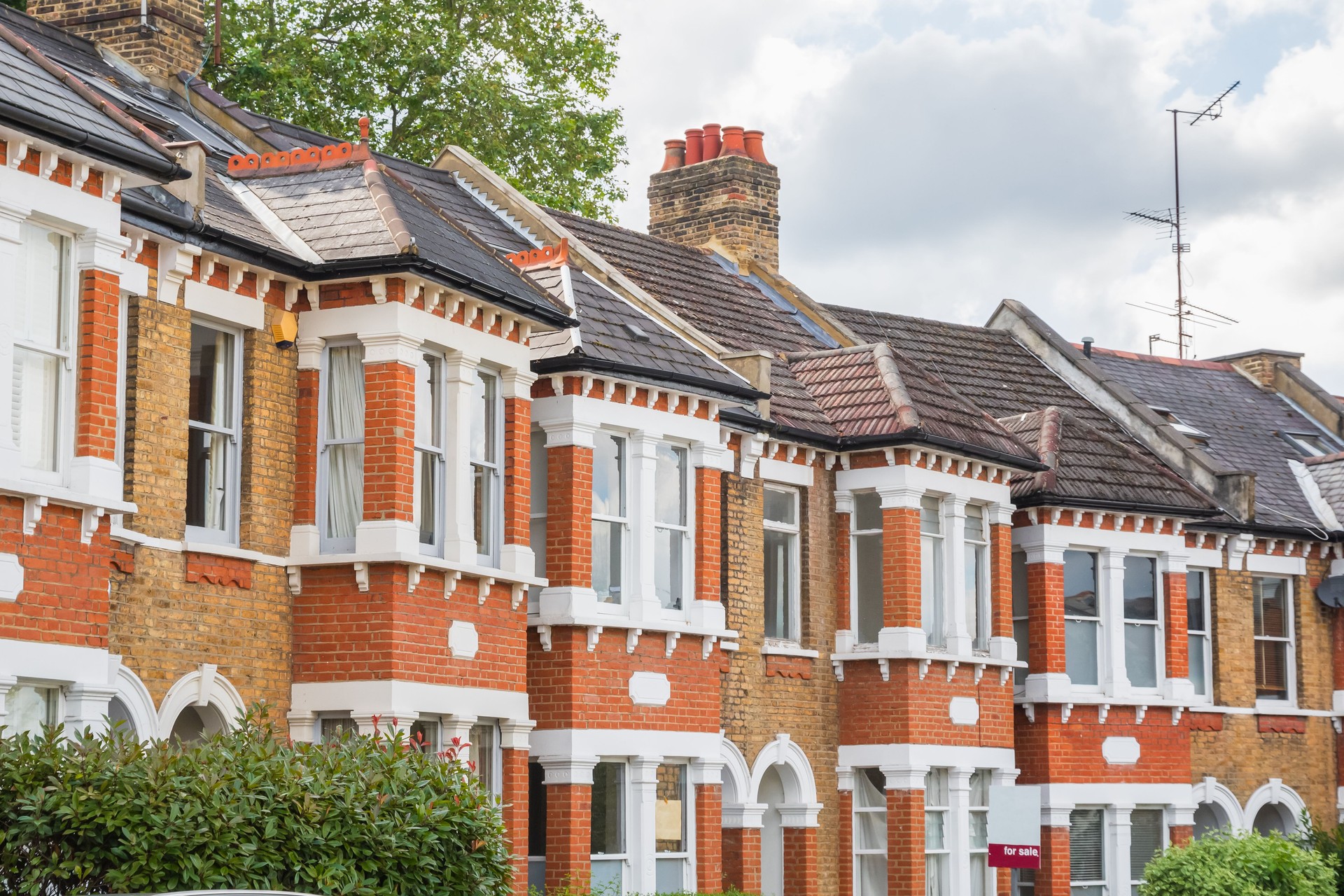 English terraced houses with a for sale sign in Crouch End, London